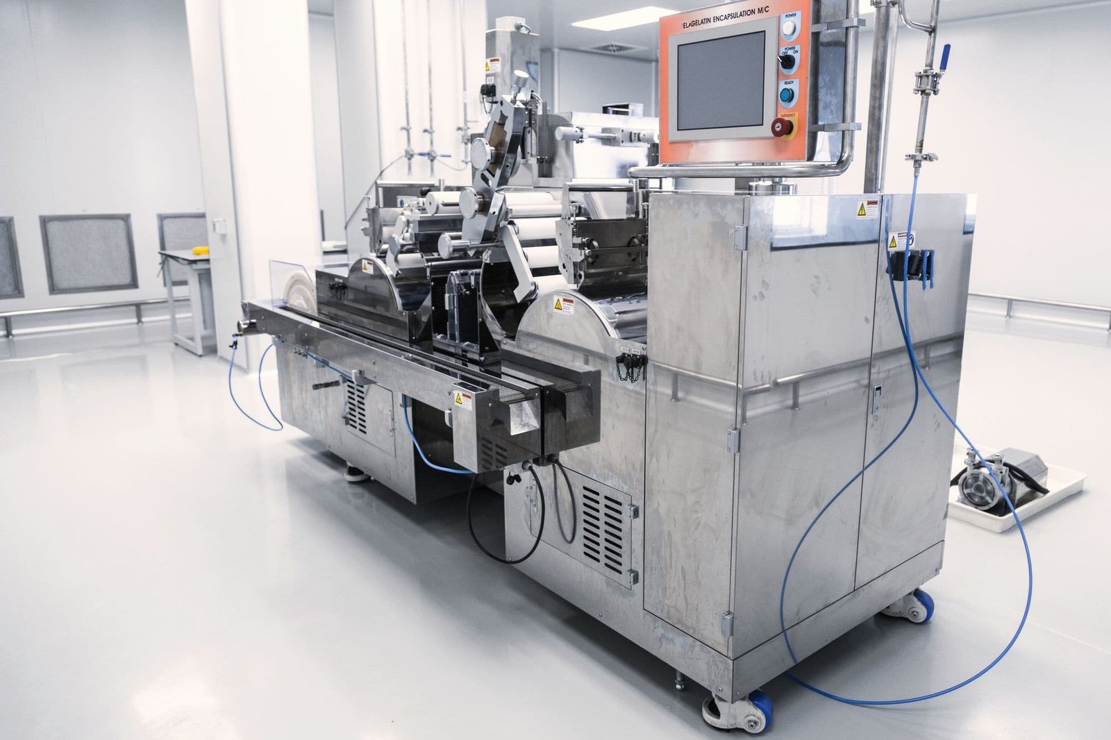 A stainless production machine with its control terminal in a clean room